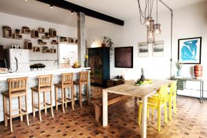cocina y comedor con mesa de madera y sillas en Casa SP011, en São Paulo