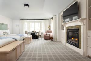 a hotel room with a fireplace and a tv at Chatham Bars Inn in Chatham