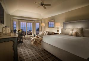 a bedroom with a large bed and a living room at Chatham Bars Inn in Chatham