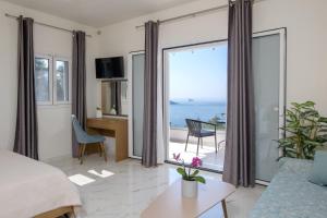 a living room with a view of the ocean at V&D Paleokastritsa Apartments in Lákones