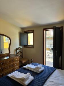 a bedroom with a bed and a dresser and a mirror at Casa Dentro da Vila in Ponte de Lima +28 photos