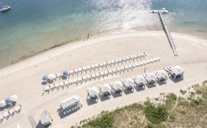 an aerial view of a beach with a bunch of chairs at Chatham Bars Inn in Chatham