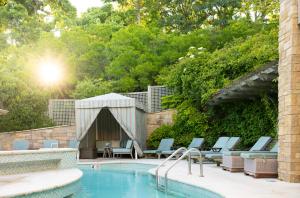 a swimming pool with lounge chairs and a tent at Chatham Bars Inn in Chatham