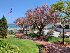 a park with trees and benches and the ocean at Chatham Bars Inn in Chatham