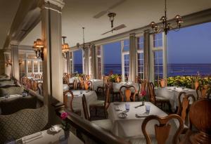 a restaurant with tables and chairs with a view of the ocean at Chatham Bars Inn in Chatham