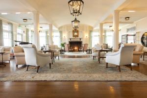 a living room with chairs and a fireplace at Chatham Bars Inn in Chatham