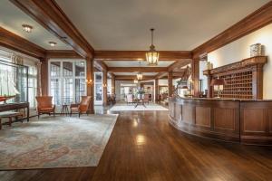 a large lobby with a bar and a piano at Chatham Bars Inn in Chatham