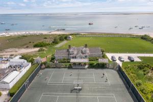 an aerial view of a house with a tennis court at Chatham Bars Inn in Chatham