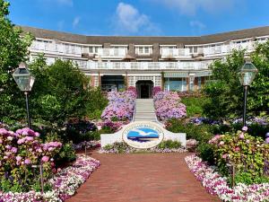 a building with a sign in the middle of flowers at Chatham Bars Inn in Chatham