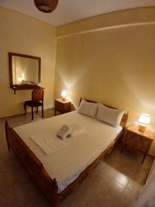a bedroom with a bed and a mirror and a desk at Ελένης apartment in Gythio