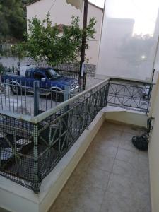 a balcony with a blue truck parked on a street at Ελένης apartment in Gythio +3 photos