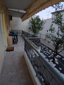a balcony of a building with a table and a piano at Ελένης apartment in Gythio