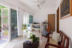 a living room with a couch and a large window at Carlota Guest House in Cozumel