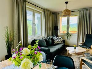 a living room with a couch and a table at Bukowe Tarasy in Wetlina