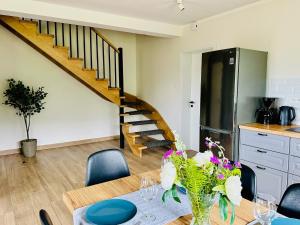 a dining room with a table and a staircase at Bukowe Tarasy in Wetlina