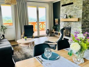 a living room with a couch and a fireplace at Bukowe Tarasy in Wetlina