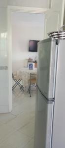 a white kitchen with a refrigerator and a table at Cup Afrique 2025 in Asilah +17 photos