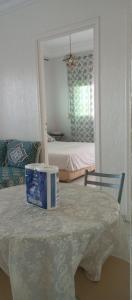 a room with a table with a box on it at Appartement avec piscine in Asilah +17 photos