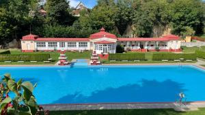 a large swimming pool in front of a building at Četnická Stanice Mšeno in Mšeno