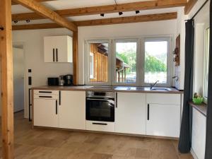 a kitchen with white cabinets and a sink at Zum Ilmwinkel in Bad Sulza