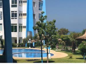 a swimming pool in front of a building at Appartement avec piscine in Asilah