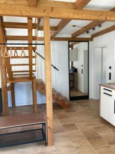 a kitchen with a wooden spiral staircase in a house at Zum Ilmwinkel in Bad Sulza +9 photos
