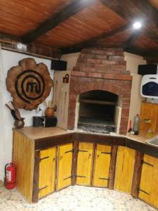 a kitchen with a brick oven in the wall at Casa Marinela in Haţeg