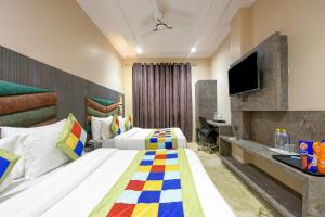 a hotel room with two beds and a television at Hotel Pearl Plaza - Paharganj - New Delhi in New Delhi +55 photos