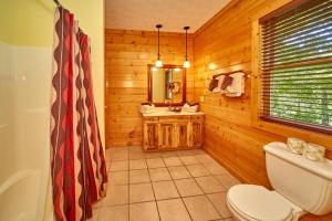 a bathroom with a toilet and a sink at A Grand View Lodge #540 in Gatlinburg +50 photos