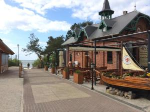 a building with a boat on the side of a street at Sea View Slavia in Międzyzdroje