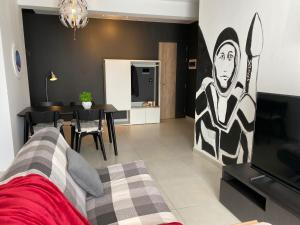 a living room with a couch and a dining room at New Stylish Design Apartment in St Julian's