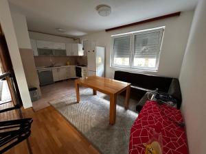 a living room with a table and a couch at Ilidza Apartments in Sarajevo