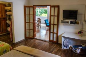 a room with a door open to a living room at Loft - Vila São José in Araras Petropolis