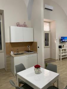 a kitchen with a white table and a sink at La Petite Maison in Naples