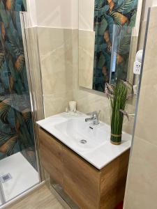 a bathroom with a sink and a shower at La Petite Maison in Naples