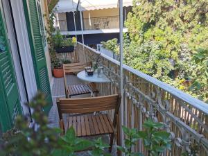 a balcony with two chairs and a table at Petrasdream Lefkada in Lefkada