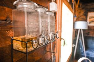 an empty glass jar on a wall with a lamp at Domaćinstvo Pešića in Lubnice