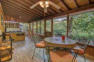 a screened in porch with a table and chairs at Bear Cabin #462 in Gatlinburg