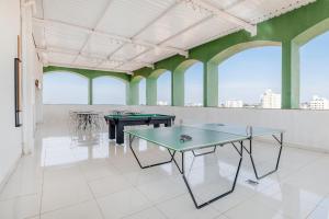 a room with two ping pong tables and windows at Hotel Nacional Inn Limeira in Limeira