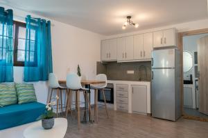 a kitchen and living room with a refrigerator and a table at Allegro seasight appartment in Livadi Astypalaias