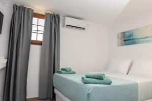 a bedroom with a bed with towels on it at Allegro seasight appartment in Livadi Astypalaias