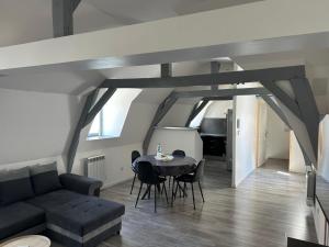 a living room with a couch and a table at Mariya Appart Moment in Saint-Omer