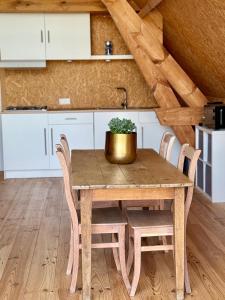 a kitchen with a wooden table with a potted plant on it at Saules et Têtards in Frasnes-lez-Anvaing +10 photos