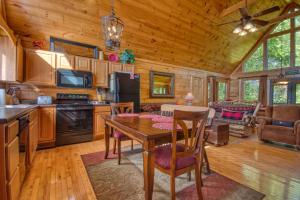 a kitchen and living room with a table in a cabin at Buckhead #259 in Sevierville