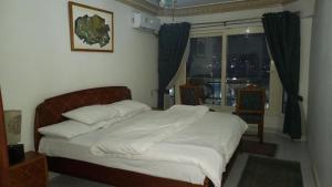 A bed or beds in a room at Nile House