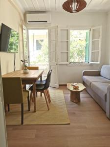 a living room with a table and a couch at Petrasdream Lefkada in Lefkada