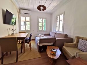 a living room with a couch and a table at Petrasdream Lefkada in Lefkada