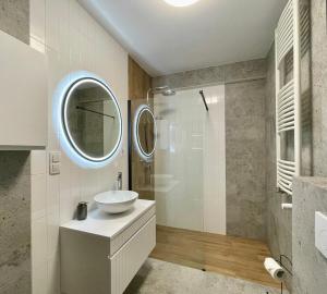 a bathroom with a sink and a mirror at Oaza Przystań in Giżycko