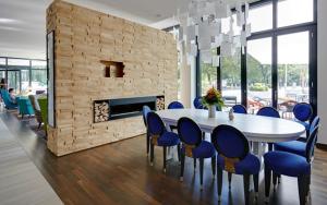 a dining room with a table and chairs and a fireplace at Grimm's Potsdamer Platz in Berlin