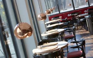 a row of tables and chairs in a restaurant at Grimm's Potsdamer Platz in Berlin
